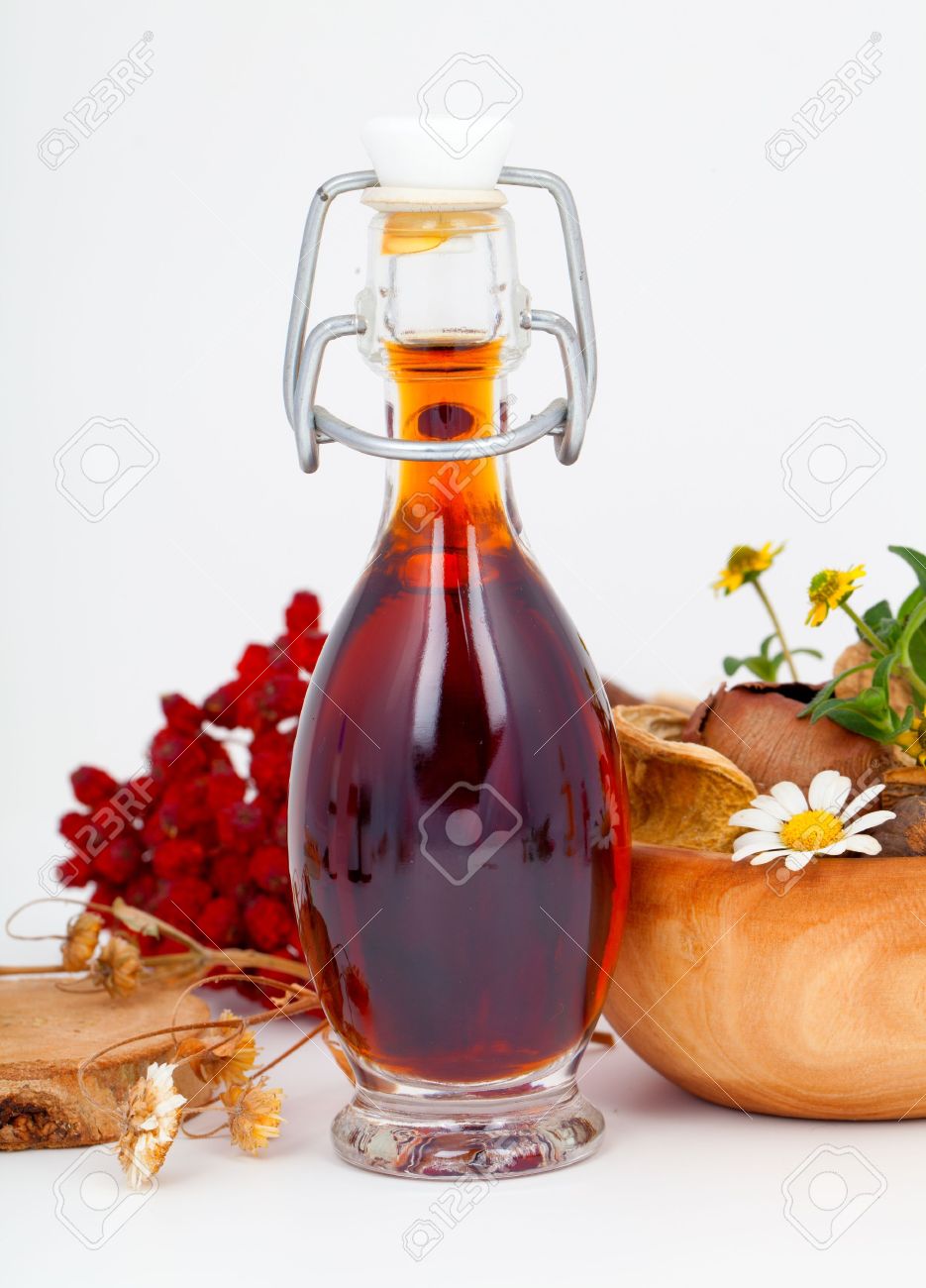 14732699-mixture-syrup-with-rowan-berries-and-herb-on-white-background--Stock-Photo